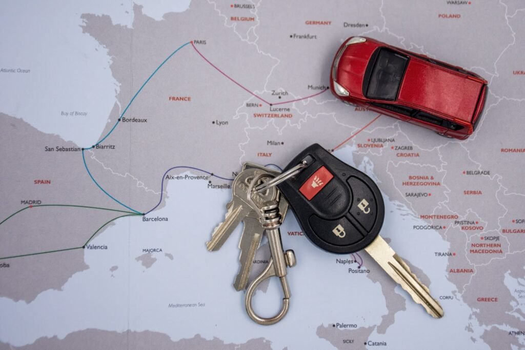 A road map and a set of car keys laid out on a table