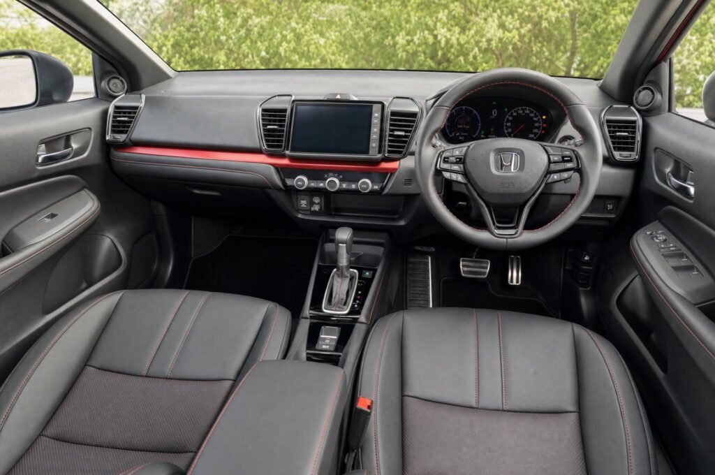 Front cabin of the Honda City, showing the dashboard, steering wheel and front seats