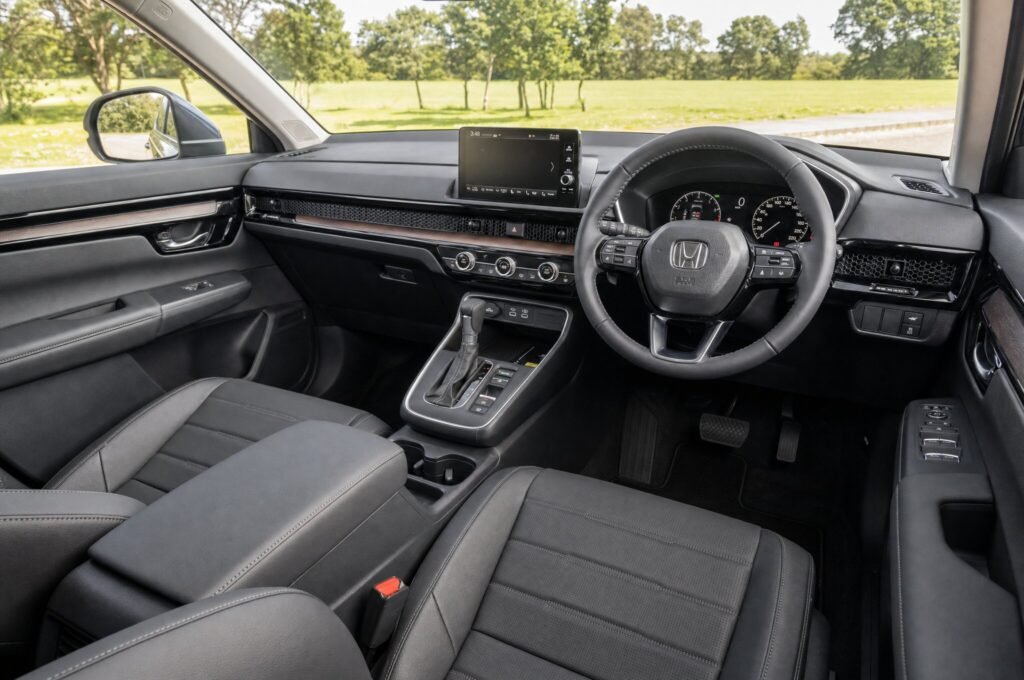 Front cabin of the Honda CR-V, showing the dashboard, steering wheel and front seats