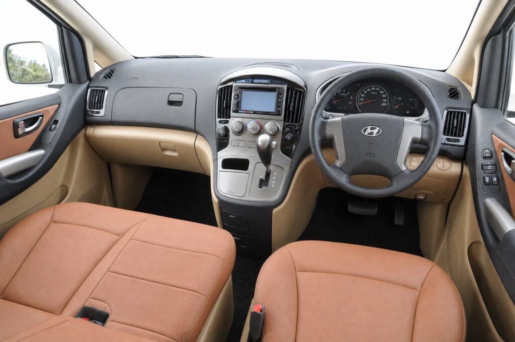 Front cabin of the Hyundai Starex, showing the dashboard, steering wheel and front seats