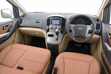 Front cabin of the Hyundai Starex, showing the dashboard, steering wheel and front seats