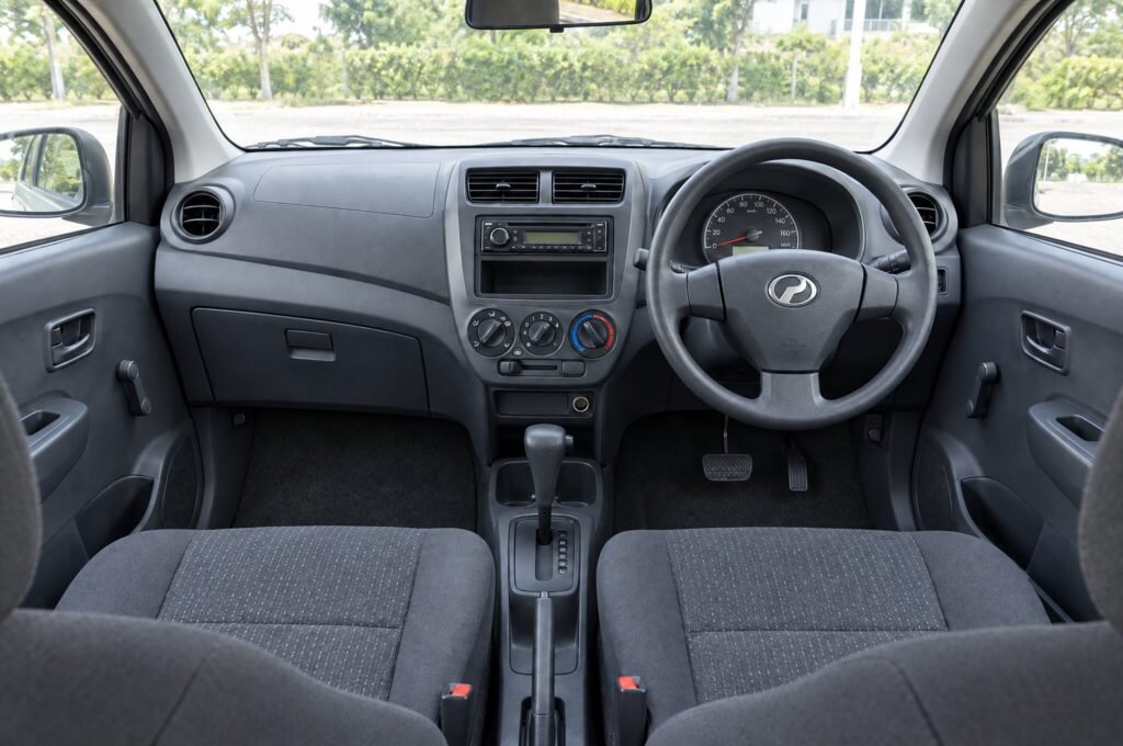 Front cabin of the Perodua Axia, showing the dashboard, steering wheel and front seats