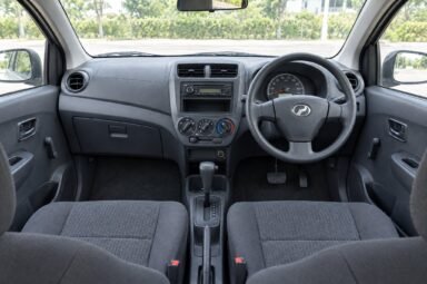 Front cabin of the Perodua Axia, showing the dashboard, steering wheel and front seats