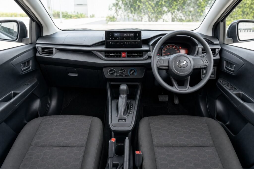 Front cabin of the Perodua Axia (Facelift), showing the dashboard, steering wheel and front seats