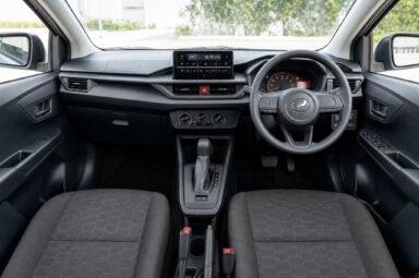 Front cabin of the Perodua Axia (Facelift), showing the dashboard, steering wheel and front seats
