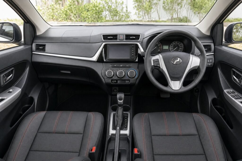Front cabin of the Perodua Bezza, showing the dashboard, steering wheel and front seats