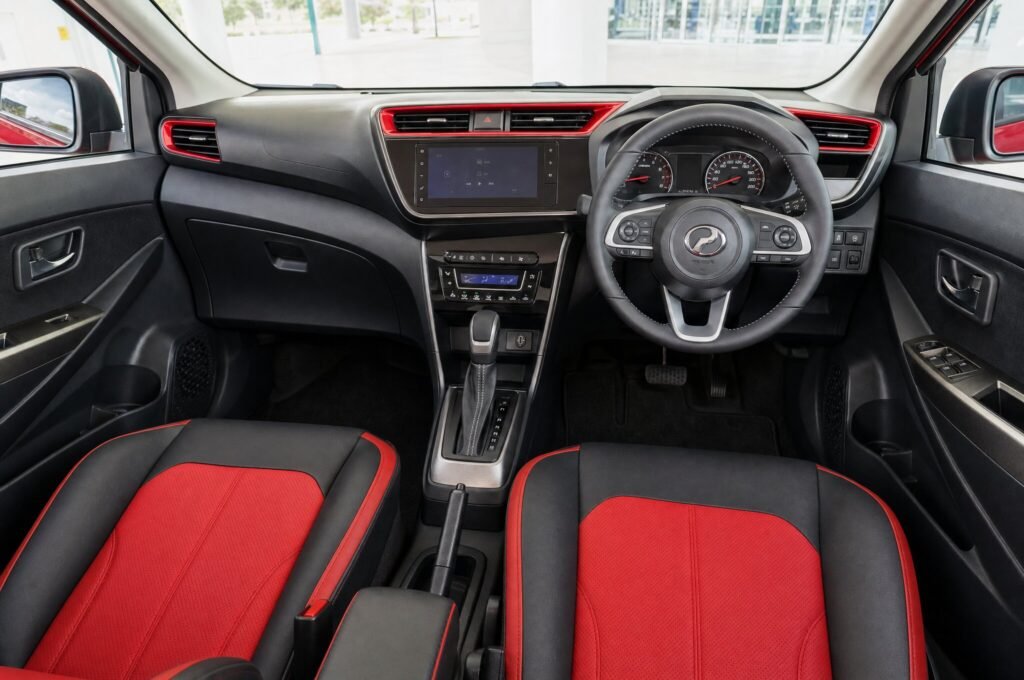 Front cabin of the Perodua Myvi, showing the dashboard, steering wheel and front seats