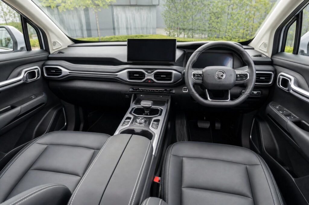 Front cabin of the Proton X90, showing the dashboard, steering wheel and front seats