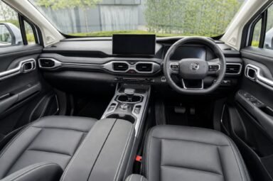 Front cabin of the Proton X90, showing the dashboard, steering wheel and front seats
