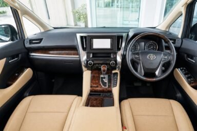 Front cabin of the Toyota Alphard (AGH30), showing the dashboard, steering wheel and front seats