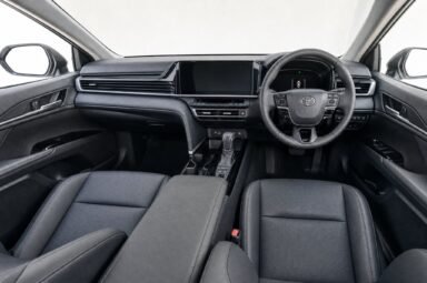 Front cabin of the Toyota Camry, showing the dashboard, steering wheel and front seats