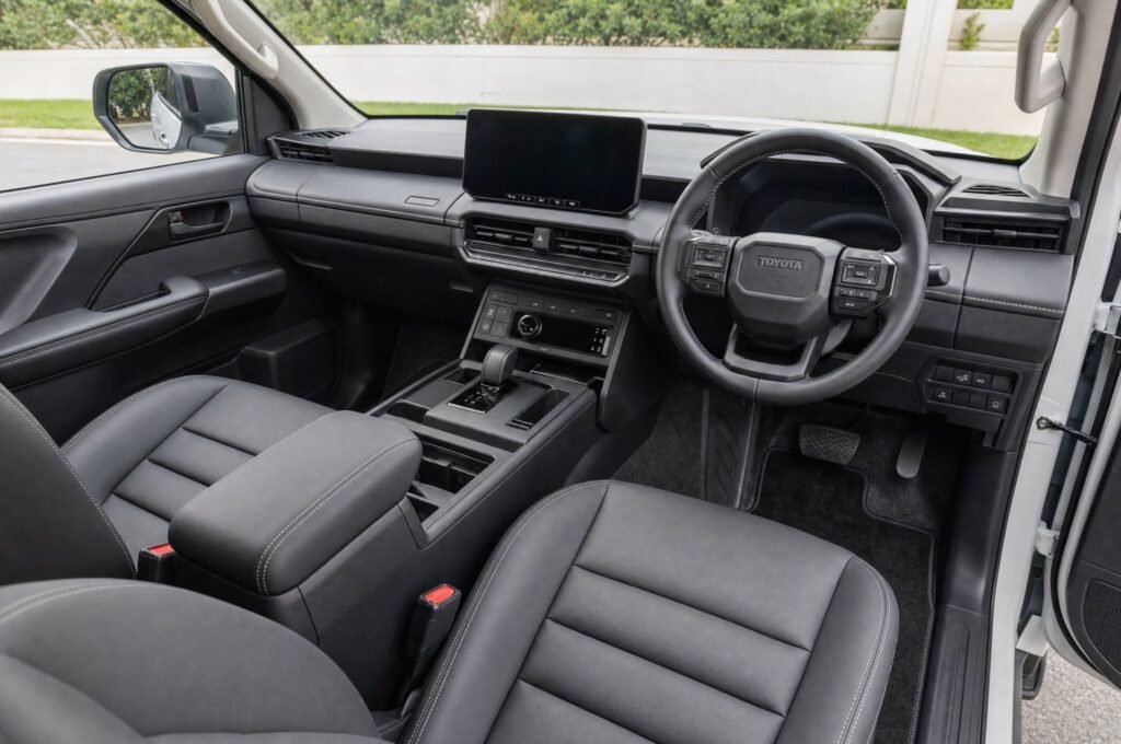 Front cabin of the Toyota Hilux, showing the dashboard, steering wheel and front seats